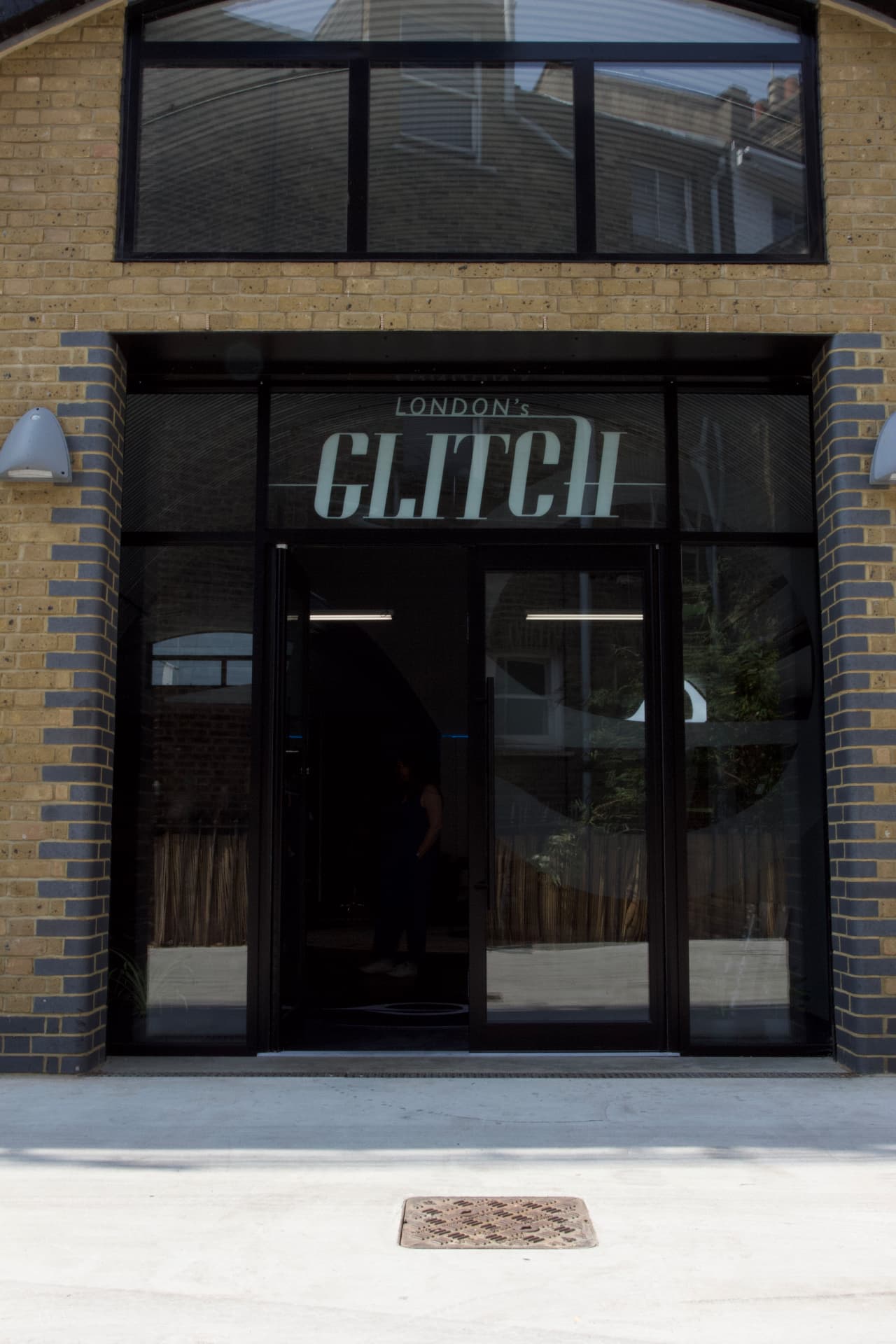 The London's Glitch storefront on Southwark Bridge Road — glass entrance between tan and grey brick
