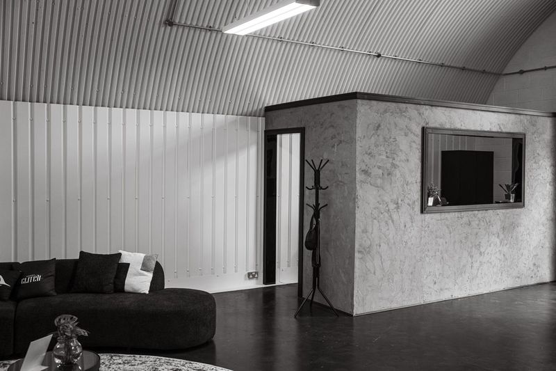 The lounge corner taking shape with the first sofa in place beside the private room wall