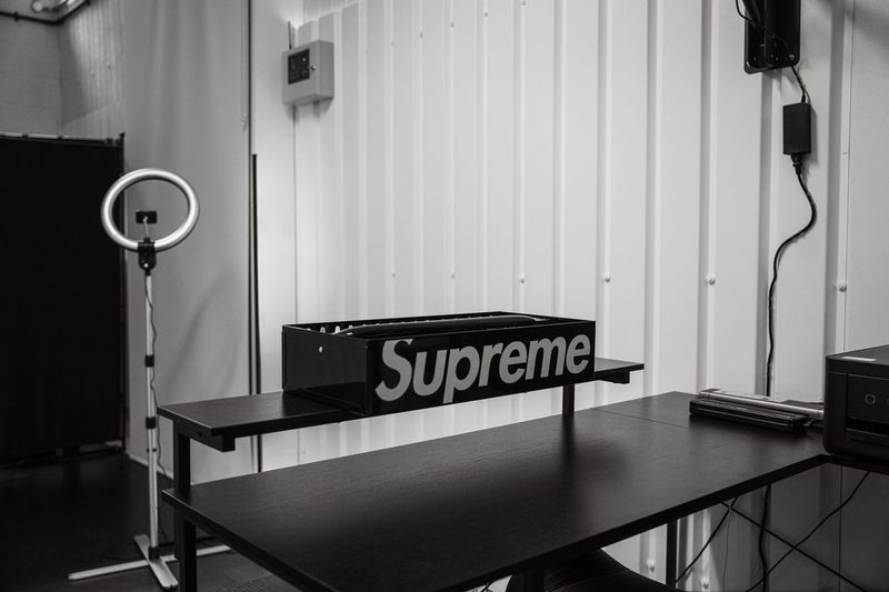 Private station being set up with its desk and ring light against fresh wall panelling
