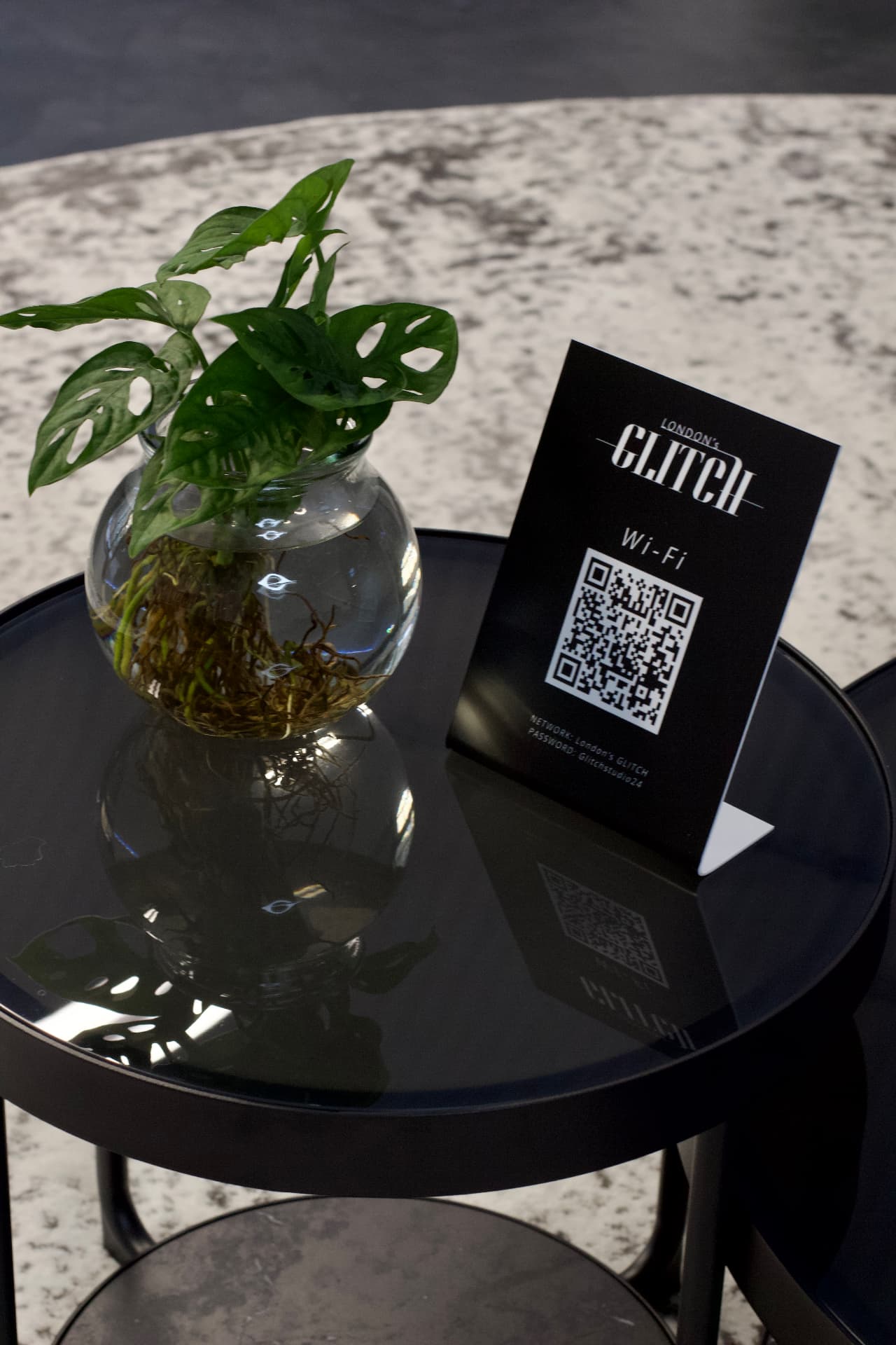 Aftercare card and planting on a table in the London's Glitch studio lounge
