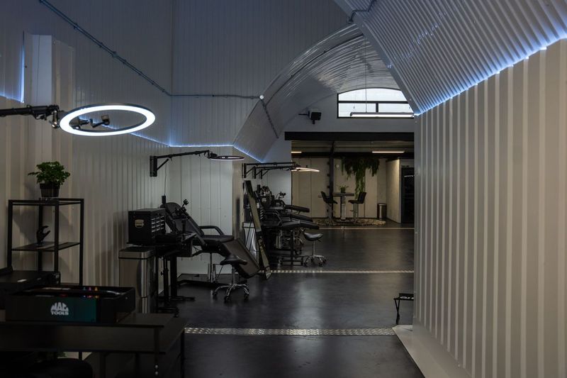 Looking down the arch past the tattooing stations towards the front of the studio