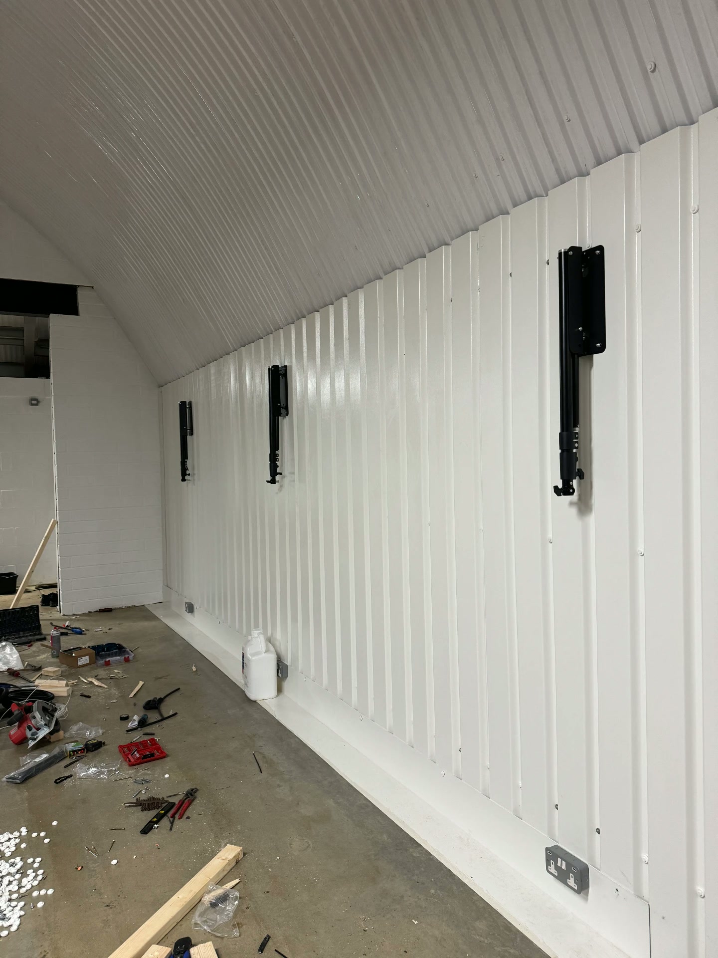 New wall panelling and speaker mounts going in, tools and offcuts still on the floor